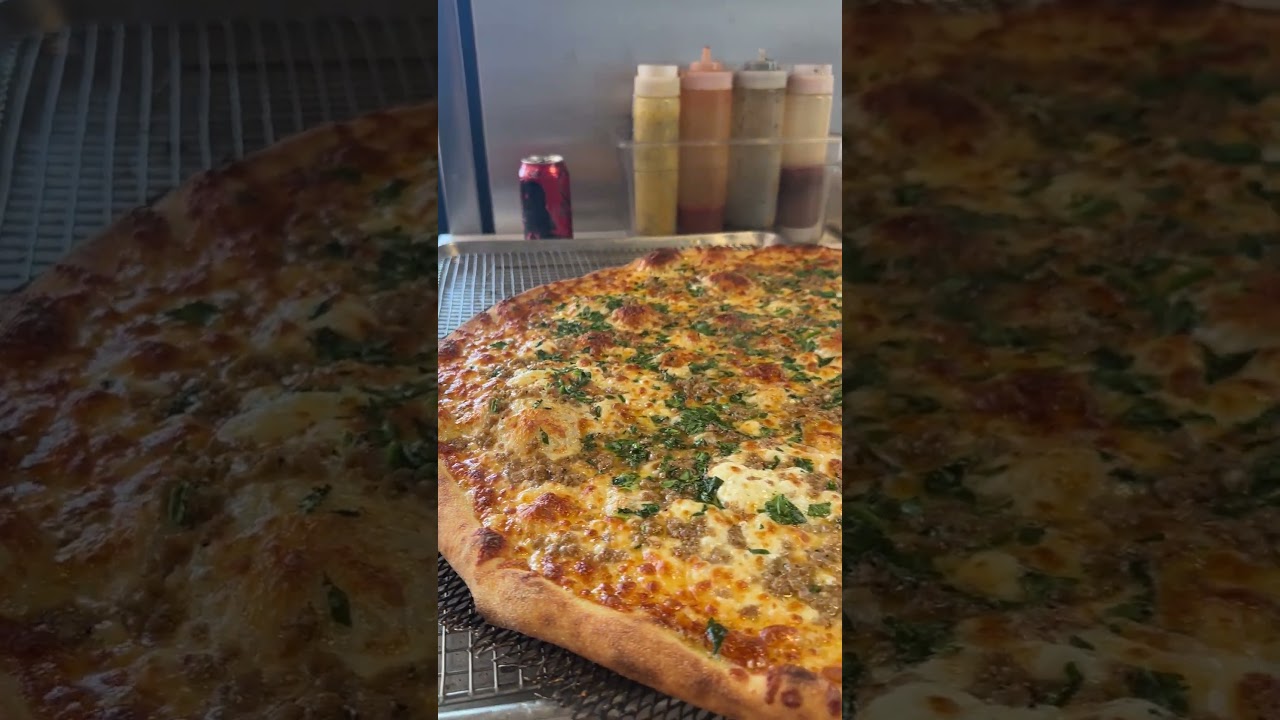 Spinach and sausage pizza fresh out of the oven