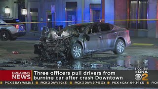 Police officers rescue man from burning car after Downtown crash