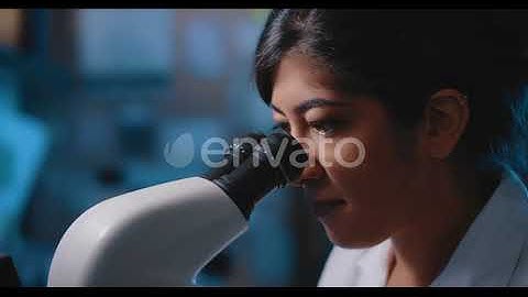 Female Research Scientist Looking at Samples Under Microscope | Stock Footage - Envato elements