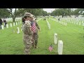 Volunteers place flags at Fort Sam Houston Cemetery