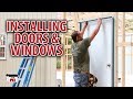 Installing doors  windows on our diy shop building kits