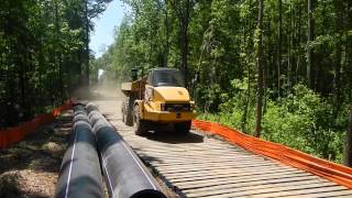 Crane mat road, laminated mat road with Cat 725 for pipeline mat work.