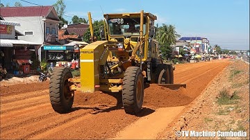 Heavy equipment operator with fast caterpillar 12h motor grader grading gravel road