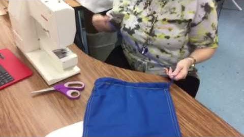 Drawstring bag strings into side seam