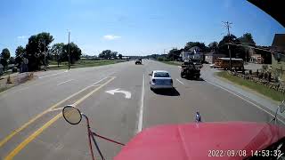 Car switches lanes and almost stops in front of truck.