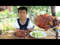 Little boy in countryside cooking with confidence / Little boy Seyhak cook pig leg