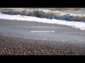 Waves on a pebble beach. Free HD stock footage.