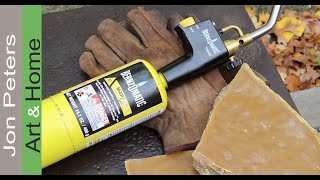 Learn how to burn in a beeswax finish on a steel table using a hand torch. The steel work table will be used outside and the 