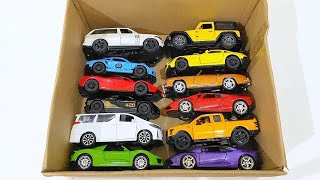 Box full of various miniature cars Toyota Vellfire, Land Rover Defender, Range Rover, Maybach