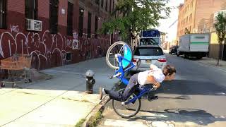 Guy rides Citi bike up handicap ramp then falls forward and lands on his stomach