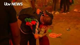 French fan consoled by Portuguese boy after loss