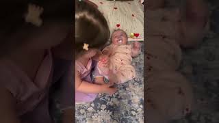 “See how the sister is tickling her brother’s feet.”