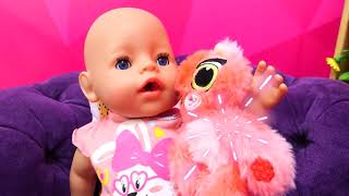 Feeding the baby doll with toy food before going for a walk with a baby bottle.