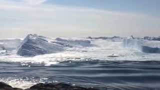 Ilulissat Icefjord  Large iceberg breaking over