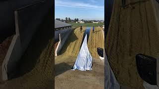 Filling and covering a corn silage bunker