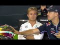 Rosberg visibly disappointed while vettel inspects his helmet