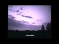 Lightning strike in the clouds above while filming distant sheet lightning