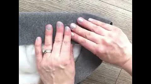Stapling a fabric corner on a DIY Upholstered Headboard