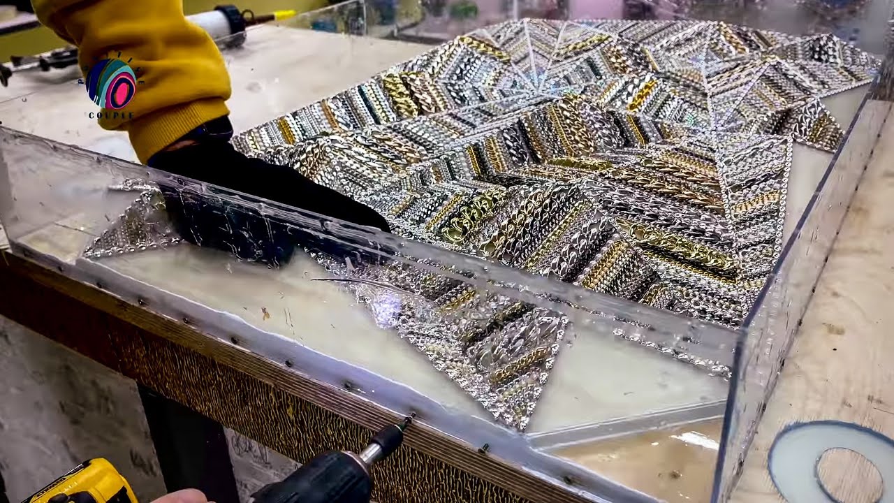 ART /  Epoxy Table made of burnt Wood and 3000 chains.