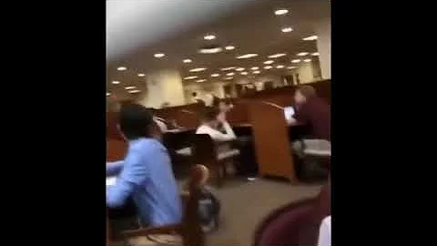 Guy releasing balloon in library