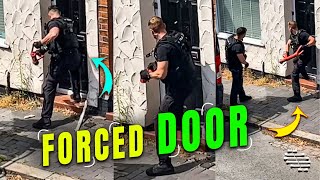 Police Members Trying to Open a Door