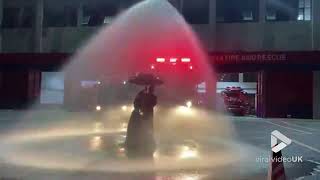 Firefighter and wife take wedding photos in rain created by fire hose || Viral Video UK