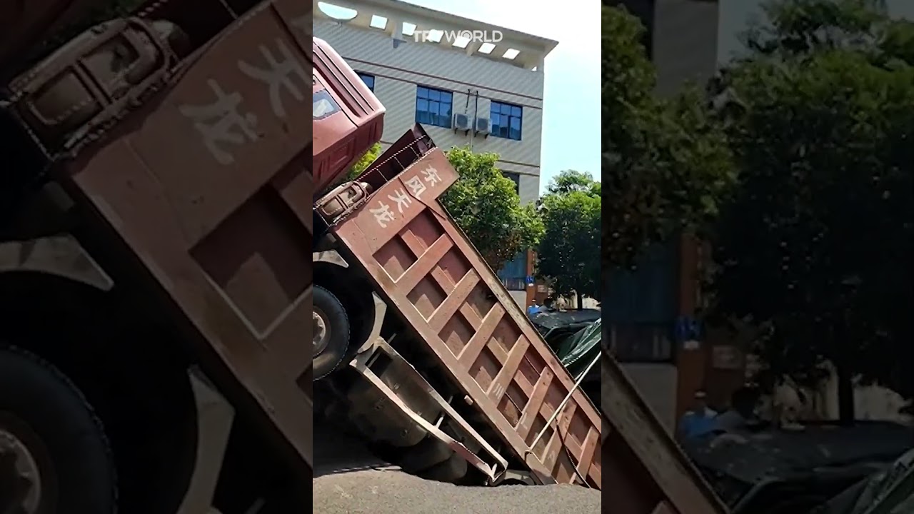 Truck swallowed by mid-road sinkhole