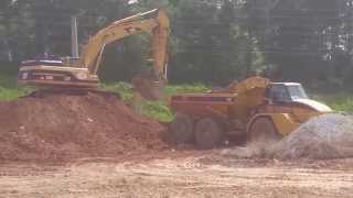 Cat 345BL loading Cat 740B