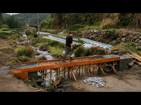 A man spends months chipping stone and pouring concrete to create his bridge over the stream 1
