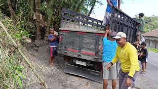 THE PROCESS OF UNLOADING SAND AND STONES FROM THE TRUCK BED