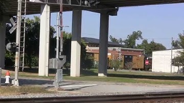 CSX GP40-2 6977 leads CSX A778-27 through downtown Valdosta, GA