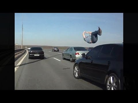 guy gets hit by car, lands perfectly on feet..