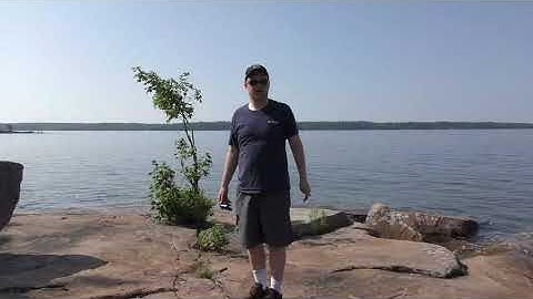 Taking a bearing with a compass to triangulate on a map