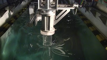 Surface piercing truncated cylinder in a forced oscillation (wide view)