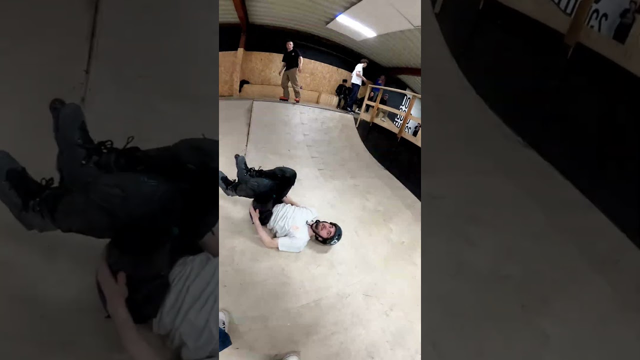 Inline skater does front flip on quarter pipe at skatepark and lands on his back