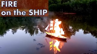 Ship on fire. Paper ship model is burning and sinking