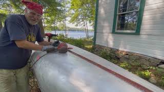 Sanding an aluminum Grumman canoe and painting it duck boat camo