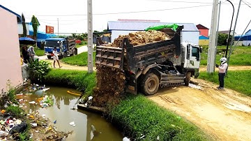 Completed Project Pushing Rock to the dirty grass , water and some of garbage by Bulldozer and truck