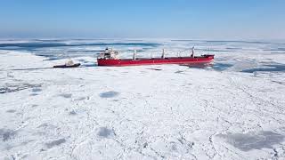 Arctic Shipping: A SLOW MOVING SHIP THROUGH ICE FLOES.