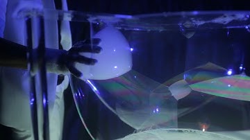 How Can He Move His Hand Through The Bubbles Without Popping Any?