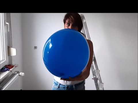 Looner girl blow to pop a blue balloon