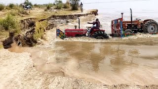 massey tractor with a fiat tractor loaded on a trolley crossing the river | tractor in river