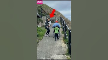Kindness on a steep path as strangers help a man in a wheelchair reach the top. #shorts