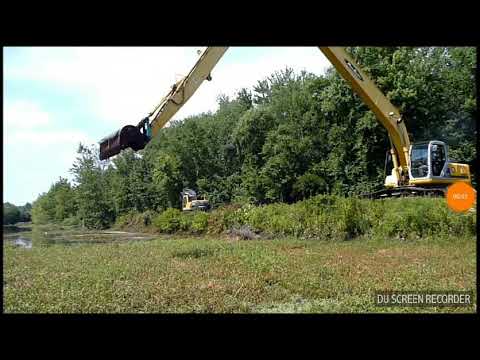 Long Reach Excavator Kobelco dredging canal. - YouTube