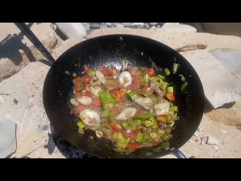 How to prepare a seafood stew with calamari squid polip leek tomatoes and pepper on the beach