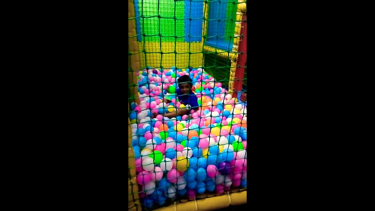 Funny little boy in ball pit for the first time