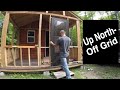 The off grid shed to cabin porch is framed and screen door installed at the weekend homestead.