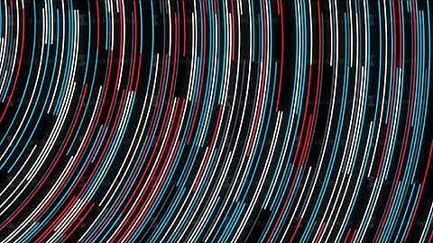Abstract colorful narrow lines moving fast on black background, seamless loop. Animation. Bended