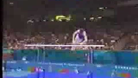 Parallel bars. Forward uprise with 1/4 to hang on 1 rail