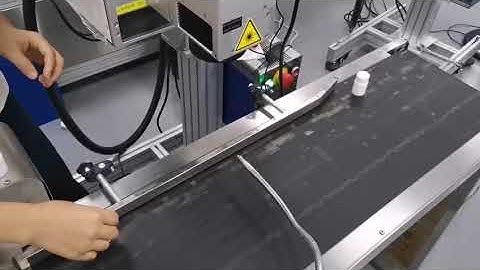 UV Laser coding printer placing date code on pharmacy bottle cap top